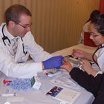 Stephen Schwartz and Jacqueline Restrepo conduct health screenings Oct. 21 at St. Pius V Parish in Pilsen.