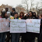 Women holding signs in support of a new health center