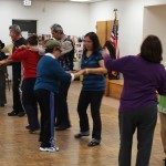 Seniors participating in a salsa dancing class