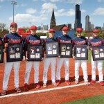 Graduating baseball players hold their commemorative plaques