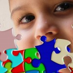 child's face behind puzzle pieces