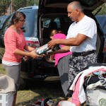 Girl and her father unpack her belongings from their car