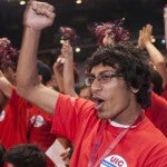 Male student in the crowd cheering