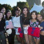 Group of students pose with Spark in the Park towels