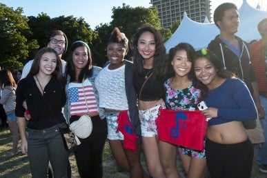 Group of students pose with Spark in the Park towels