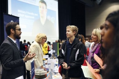 High school student speaking with UIC member