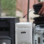 Person stacking electronics for recycling