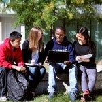 group of students looking at a computer