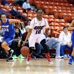 Terri Bender between two IPFW players