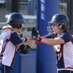 Softball players high-fiving