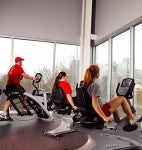 students on exercise machines with a view of the Sears Tower