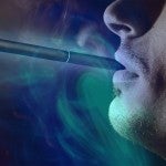 man with e-cigarette in mouth