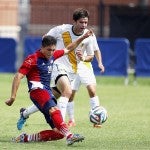 Jose Fuentes goes to the grount to kick the ball