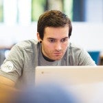 student looking at a laptop