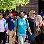 crowd of students walking on campus