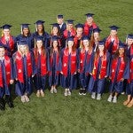 UIC athletes wearing graduation caps and gowns