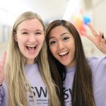 Two women giving the peace sign