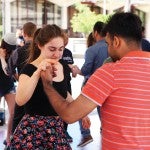 students, facutly, and staff learning dance moves