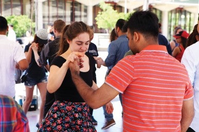 students, facutly, and staff learning dance moves