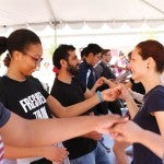 students, facutly, and staff learning dance moves