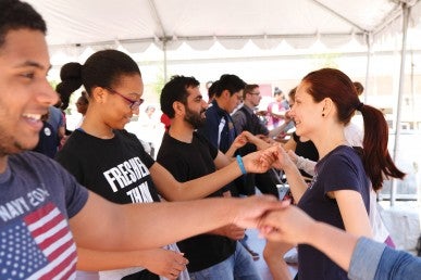 students, facutly, and staff learning dance moves