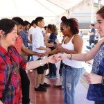 students, facutly, and staff learning dance moves