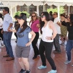 students, facutly, and staff learning dance moves