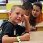 young boy sitting at a desk