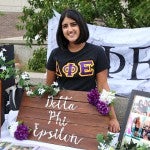 Delta Phi Epsilon sorority member and table