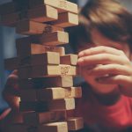 male child playing Jenga