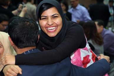 woman hugging man and smiling