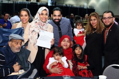 woman with her match letter and her family