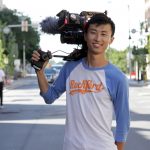 Bing Liu holding film camera on “Minding the Gap" set.