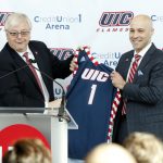 Chancellor Amiridis hands Michael Lipitz a UIC jersey.