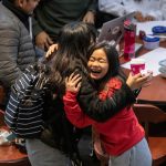 Karen Cumba (LAS '23), right, greets her friend Ria Bonjoc (LAS '23) in the atrium of SRCN after returning from winter break on the first day of spring semester Monday, Jan. 13, 2020.