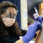 Dentistry student Inesa Tshagharyan administers COVID-19 vaccinations at the Credit Union 1 Arena on Monday, Feb. 1, 2021, at the University of Illinois Chicago. (Joshua Clark/University of Illinois Chicago)