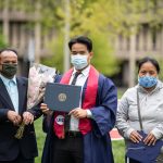 Graduate Bu Reh with his parents.