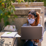 student outdoors studying