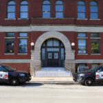 UIC Police station with two fleet vehicles parked in front.
