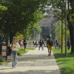 Students walking across campus in the summer.
