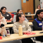 Students listen during a panel discussion.