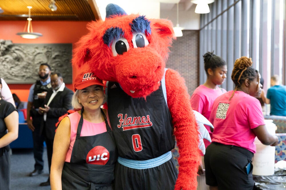 Chancellor Miranda poses with Sparky during the East Campus Ice Cream Social. Photo by Jenny Fontaine/UIC