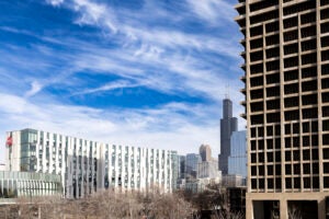 View of the Academic Residential Complex and University Hall with the Chicago skyline in the background. Photo by Jenny Fontaine/UIC