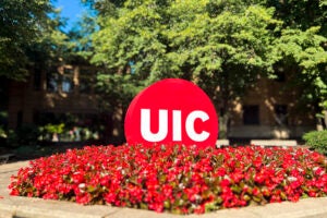 UIC Circle Mark on the east campus at the corner of Halsted and Harrison surrounded by flowers. Photo by Jenny Fontaine/UIC