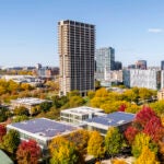 An aerial view of the University of Illinois Chicago campus, with tall buildings and colorful autumn trees