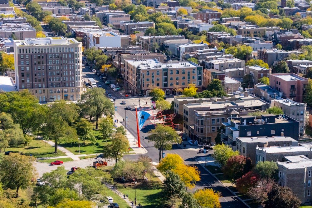 An aerial shot of Chicago's Humboldt Park neighborhood with a large sculpture of the Puerto Rican flag in the center.