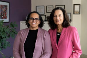 Two women stand side-by-side.