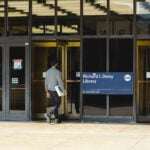 Man walking into UIC Richard J. Daley Library