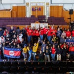 a large group of people gather for a photo in a church