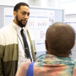 Second Year Medical Student Yarid Mera speaks to another person.